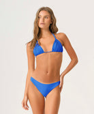 Woman wearing a blue bikini against a white background