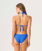 Woman wearing a blue bikini on a white background