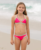 Young girl wearing a colorful bikini set on a beach