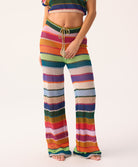 Colorful striped pants worn by a person on a white background