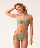 Woman wearing a patterned bikini set on a plain background