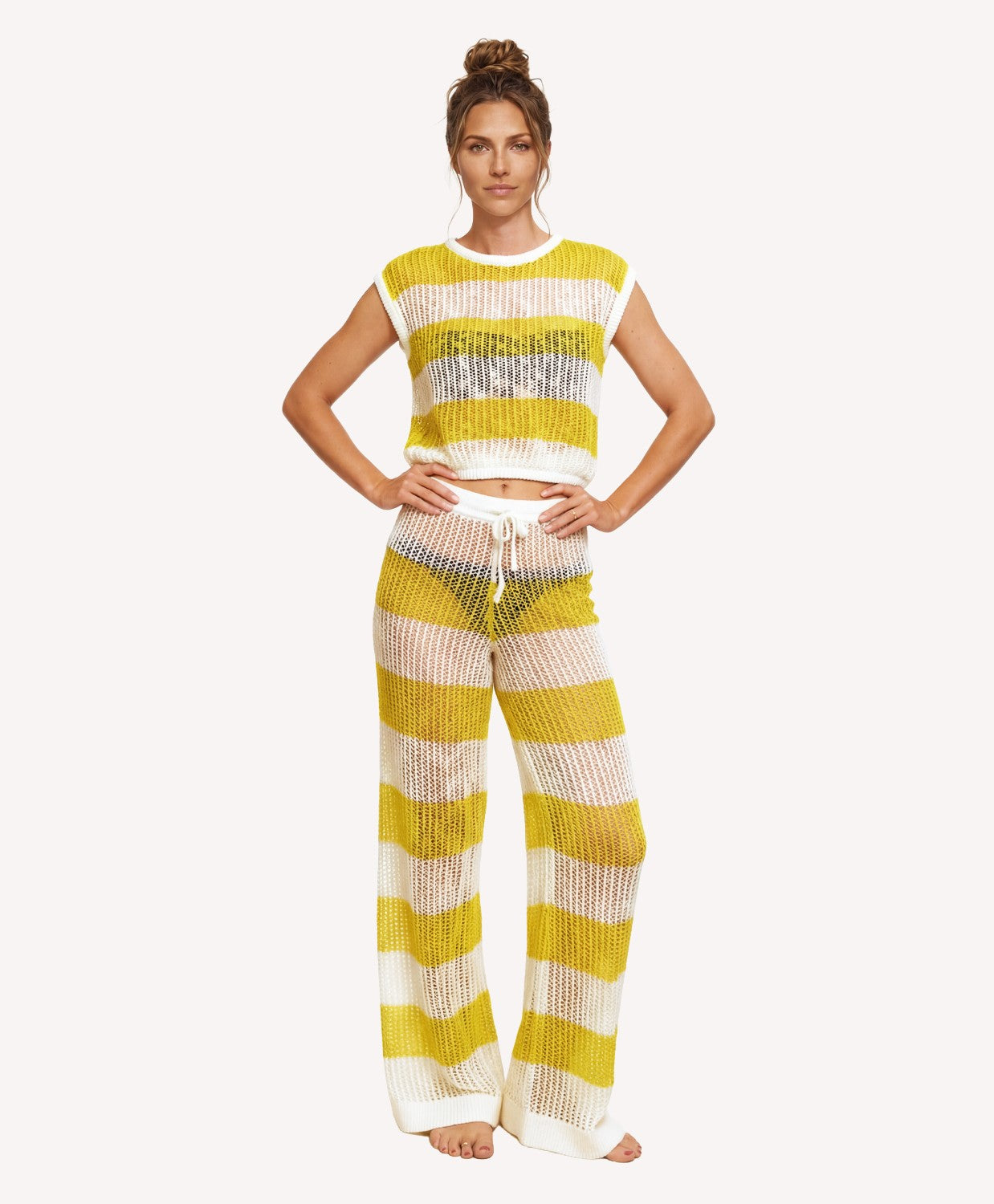 Woman wearing a yellow and white striped outfit on a white background