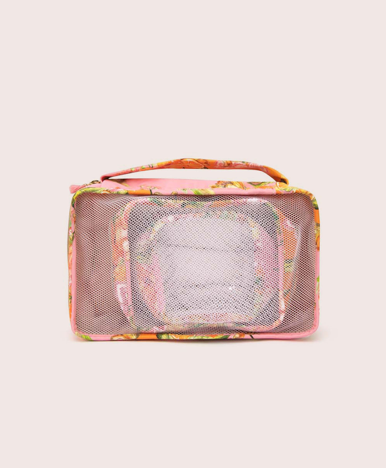 Packing cubes with an orange floral print against a white wall. 