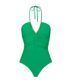 A green one piece swim suit against a white wall background. 