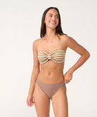 A woman modeling a two-piece bikini set against a plain light background. The bikini top is a strapless bandeau style with horizontal tan and white stripes and a ruffled bow detail at the bust.