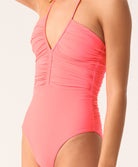 Pink one-piece swimsuit with a plunging neckline on a white background