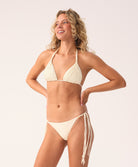 Woman wearing a beige bikini set on a white background