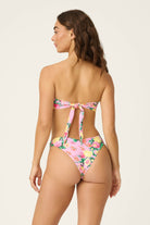 Dahlia Detail Bandeau bikini – strapless with bold florals, 24K gold embellishments, and detachable heart charm.