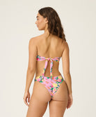 Woman wearing a floral bikini on a white background