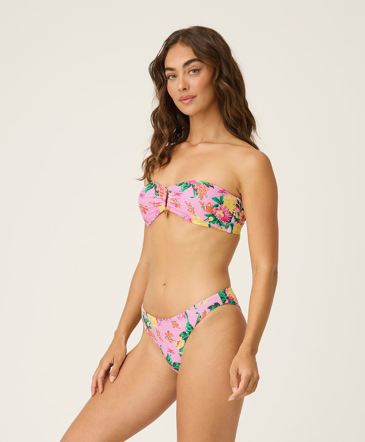 Woman wearing a floral bikini set on a plain background