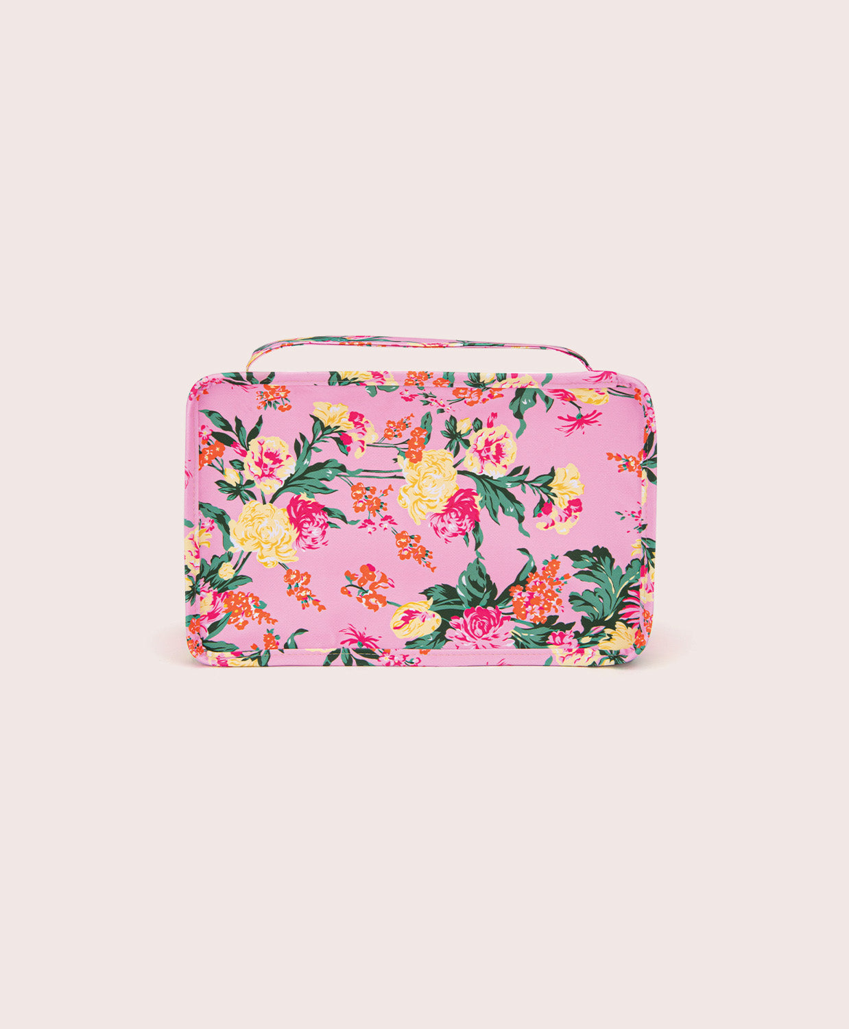 Floral-patterned pink packing cube on a light pink background