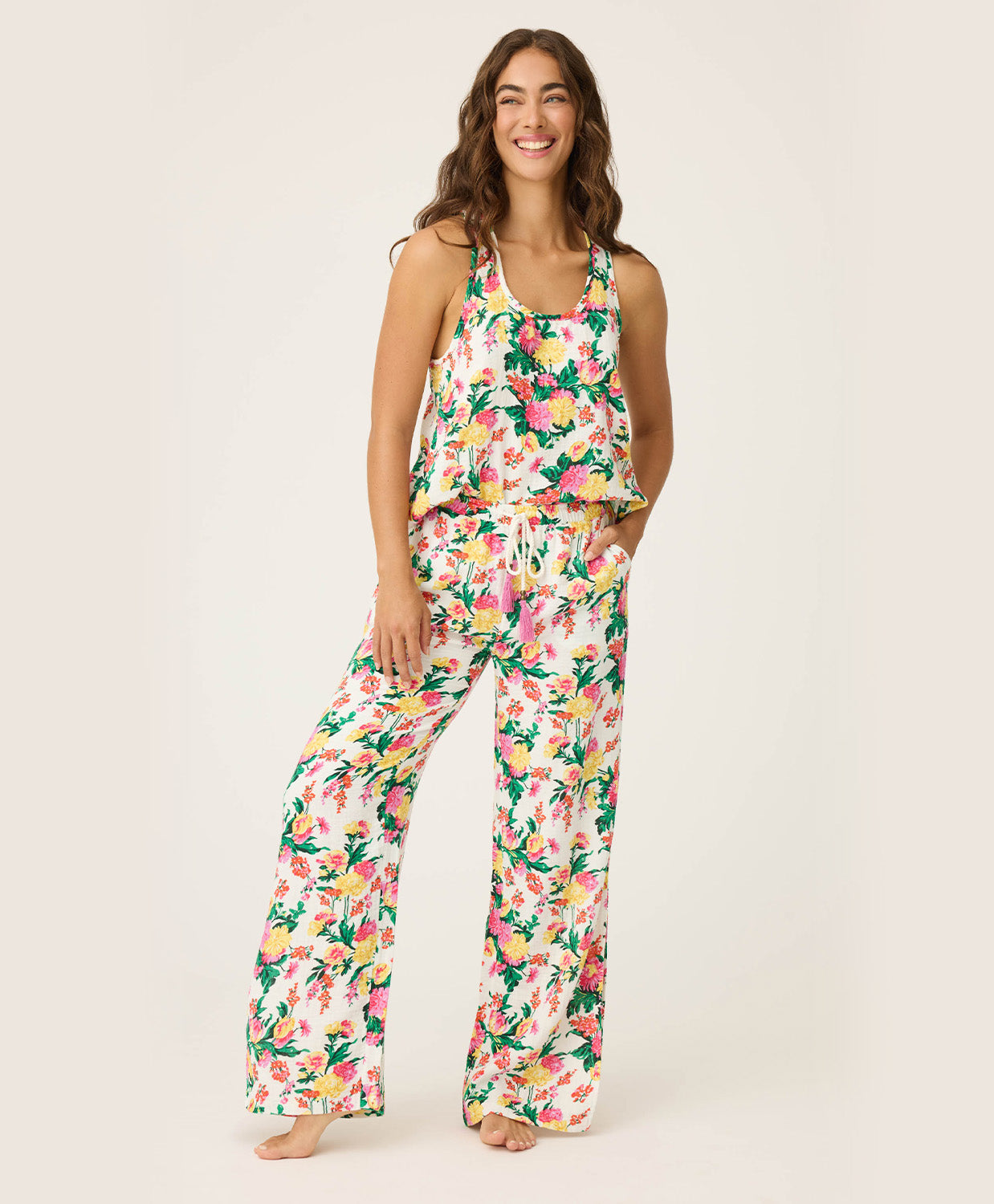 Woman wearing a floral pajama set on a plain background