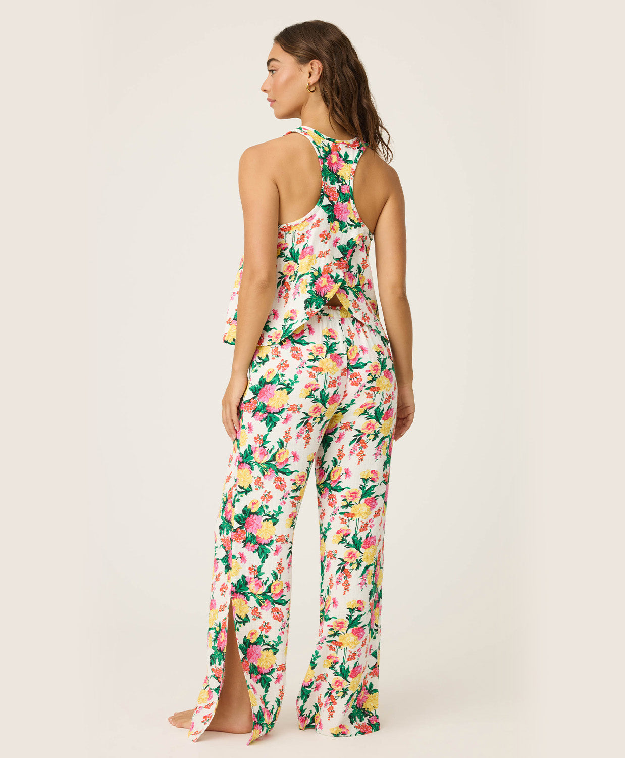 Woman wearing a floral cami and pant set on a white background