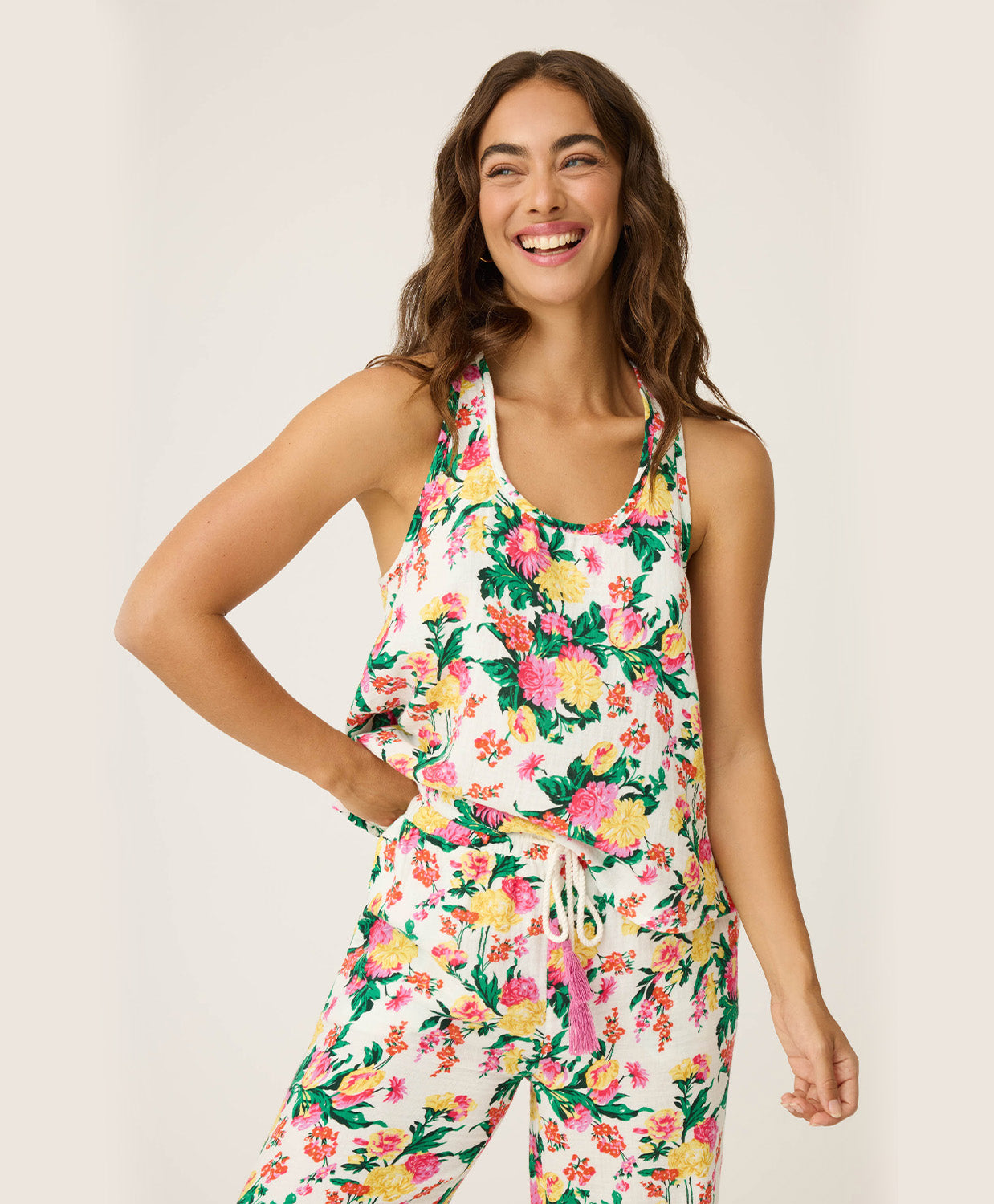 Dahlia Racerback Tank – lightweight tropical floral tank with scoop neckline and airy winged racerback, offering a relaxed, comfortable fit ideal for lounging or vacation mornings, styled with matching wide-leg pants.