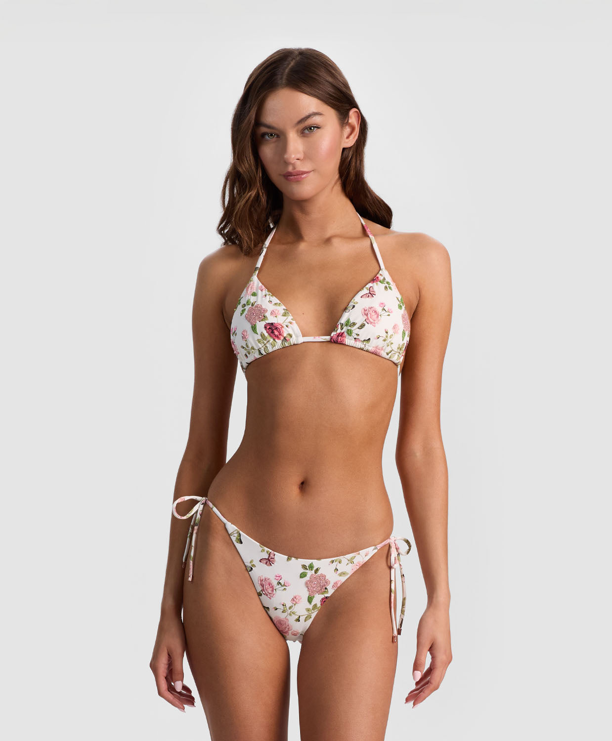 Woman wearing a floral bikini set on a white background