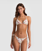 Woman wearing a floral bikini set on a white background