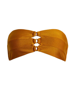 An orange bandeau bikini top with gold details. Featured against a white wall background.