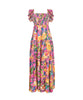 A maxi pink tropical dress with sequins. Featured against a white wall background.