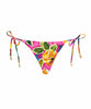 A pink tropical triangle shape bikini bottom with hand-sewn beading. Featured against a white wall background.