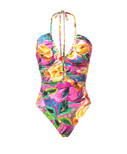 A  pink tropical print ruched one piece swimsuit. Featured against a white wall background.