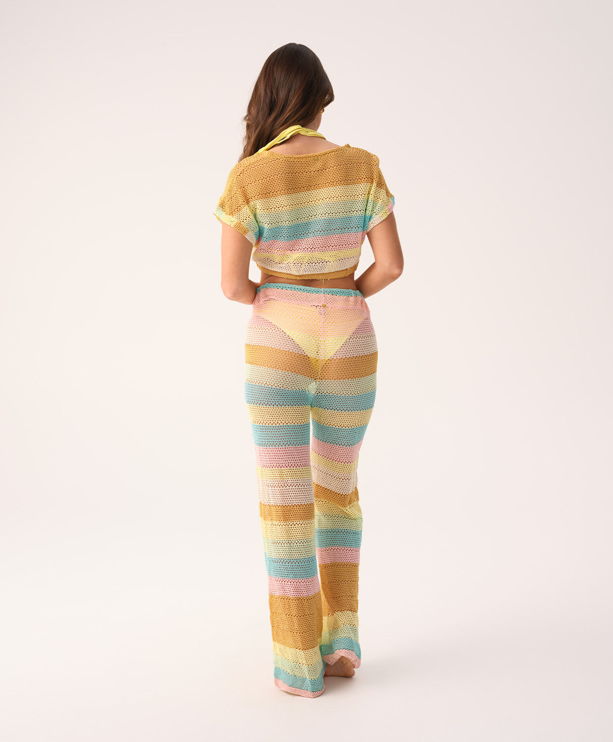 Woman wearing a colorful striped outfit on a white background