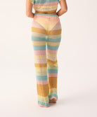Pastel striped pants worn by a person on a white background