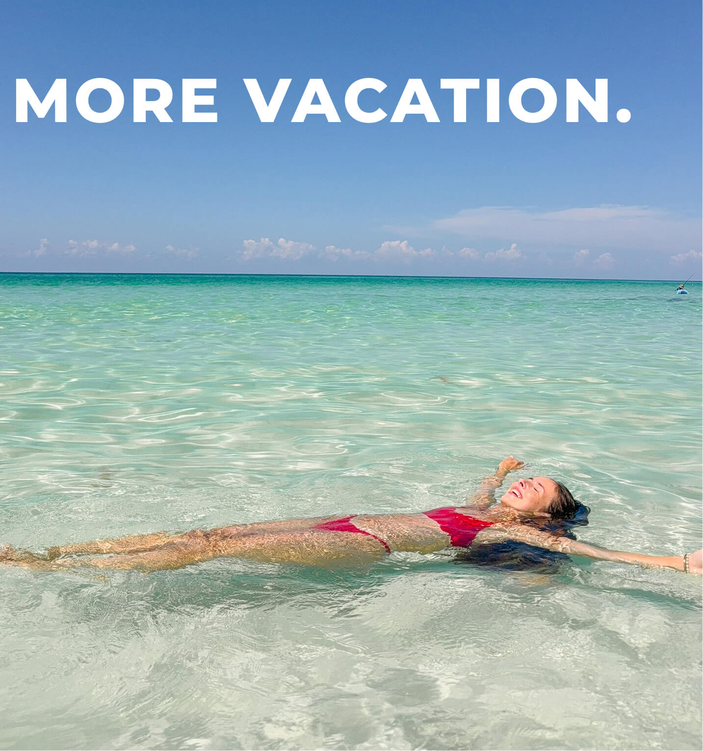 Woman laying in blue water wearing a red bikini.
