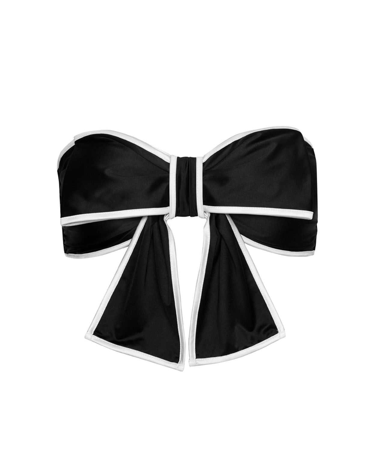 A black bikini top with a large bow against a white wall. 