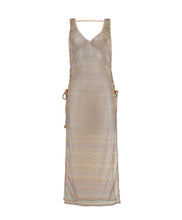 A multi-colored sleeveless lace tunic with open side slits and lace-up side details with tassel tie ends. Featured against a white wall background.