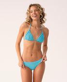 Woman wearing a blue bikini against a white background