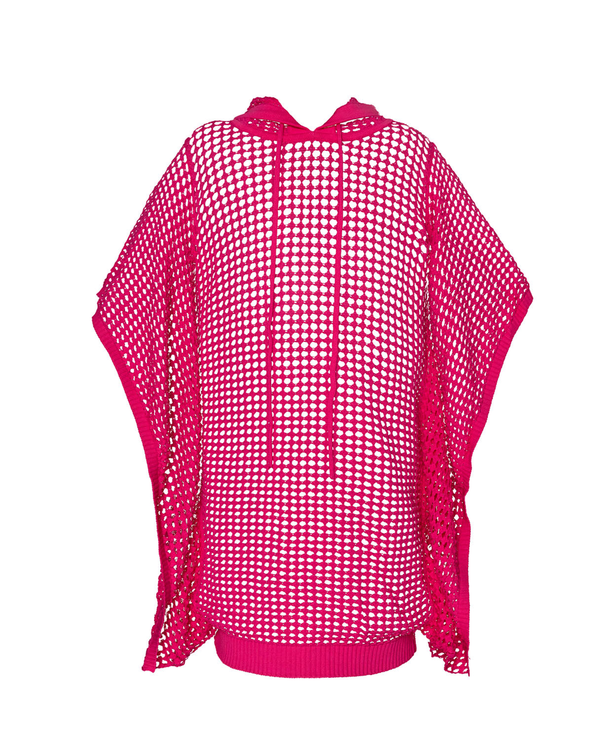 A pink knit poncho against a white wall.