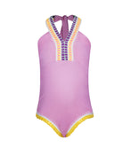 A pink one piece swim suit with colorful embroidery against a white wall. 