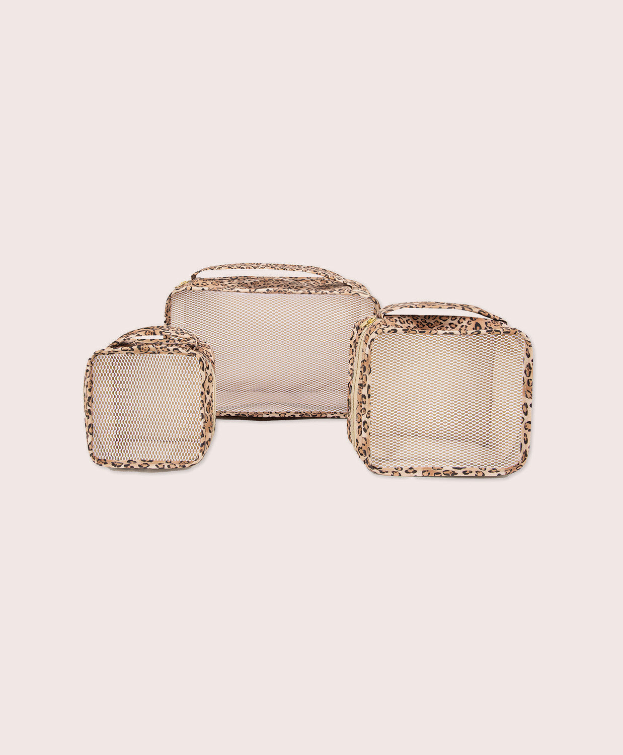 Three square mesh packing cubes with leopard borders on a light pink background