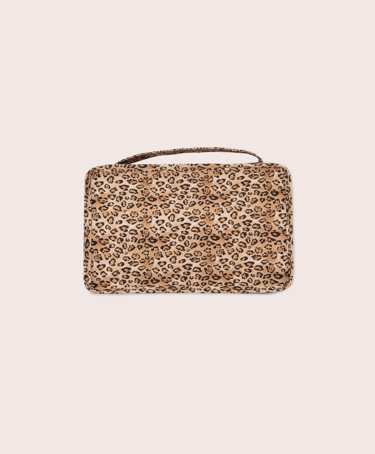 Leopard print packing cube on a beige background