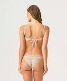 Woman wearing a colorful bikini set on a white background