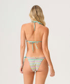 Woman wearing a colorful bikini with a white background