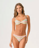 Woman wearing a colorful bikini set on a white background