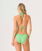 Woman wearing a green bikini set on a white background