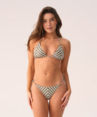 Woman wearing a striped bikini against a plain background