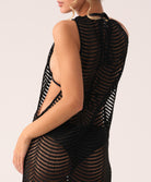 Black mesh dress with cut-out design on a plain background