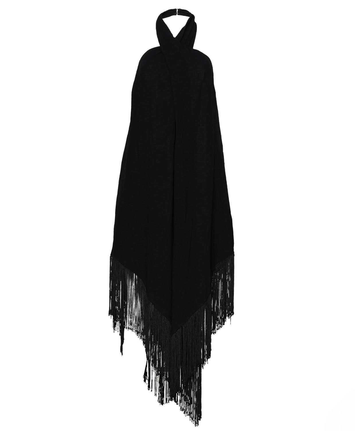 A black fringe dress that ties around the neck against a white wall.