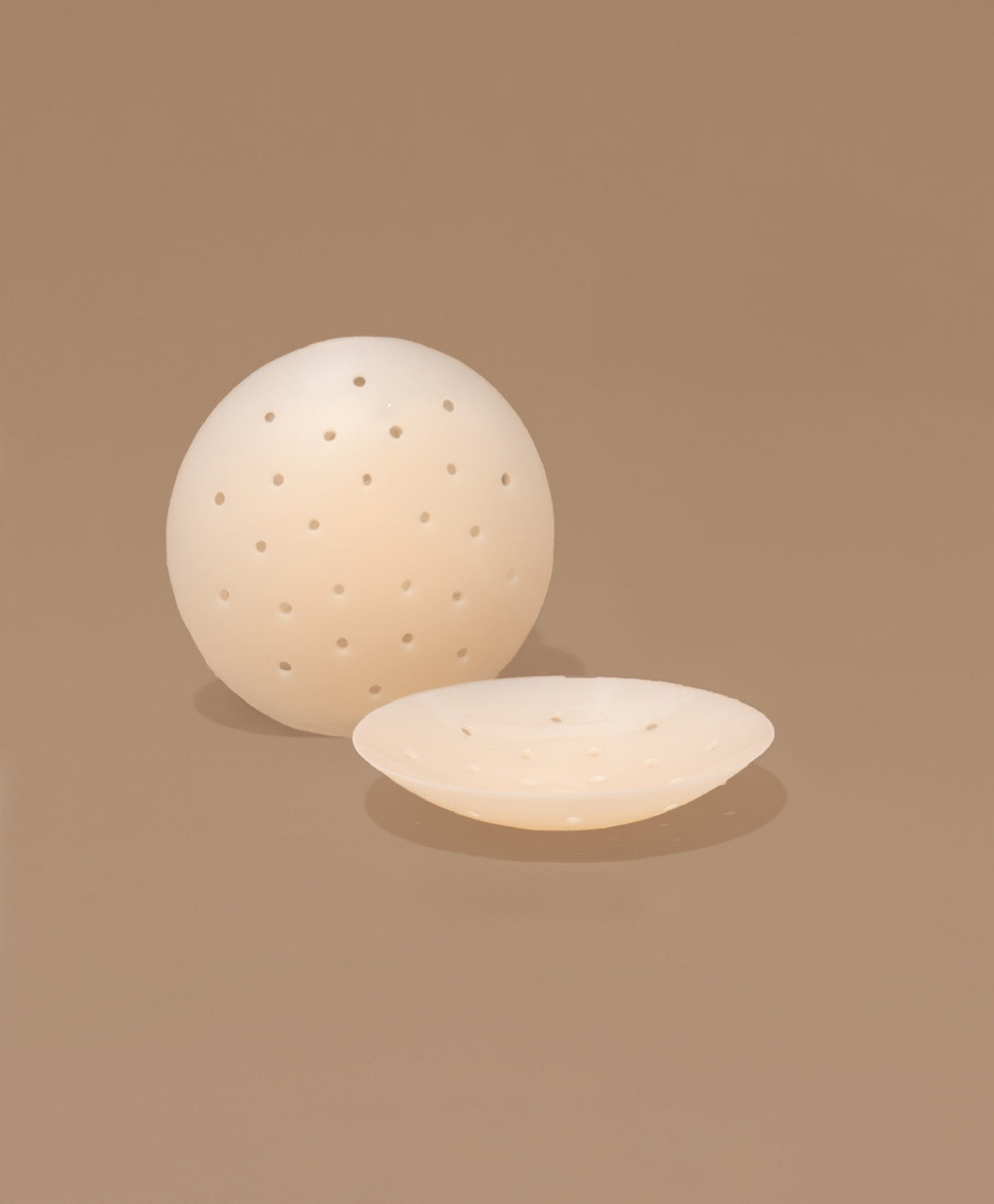 Nipple covers on brown background.