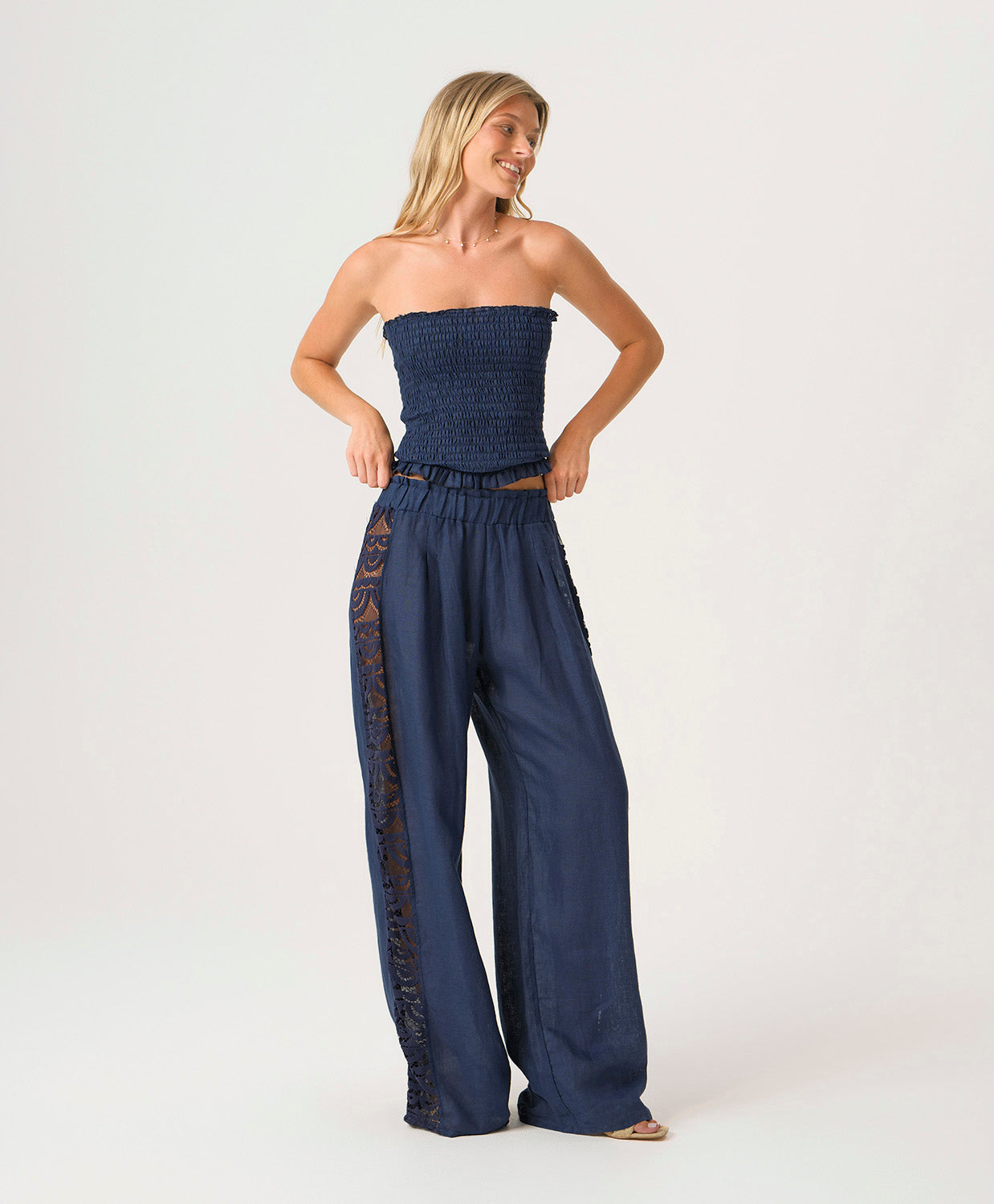 Navy Jace Lace Pant in airy navy linen with hand-cut lace side panels and a ruched waistband for a feminine, resort-ready look.