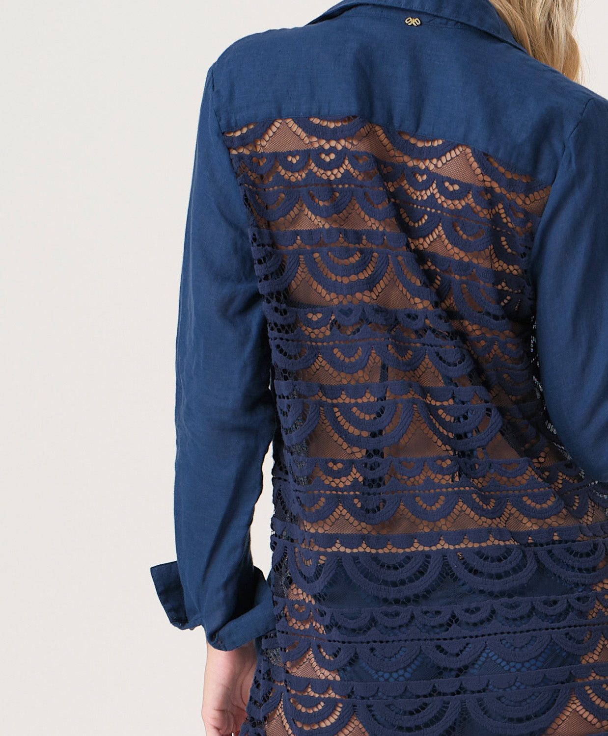 Navy tunic with lace detailing on a plain background