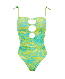 A blue and green one piece swimsuit against a white wall. 