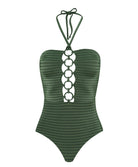 A green one piece swimsuit against a white wall.