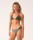 Woman wearing a green bikini set on a white background