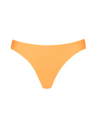 An orange bikini bottom against a white wall.