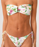Woman wearing a floral bikini set on a white background