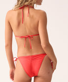 Red bikini worn by a model on a white background